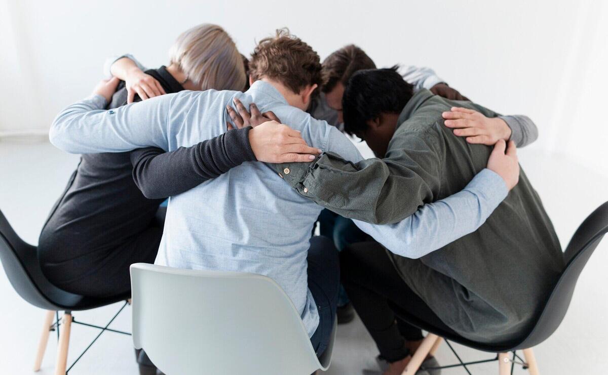 People standing on chairs and embracing