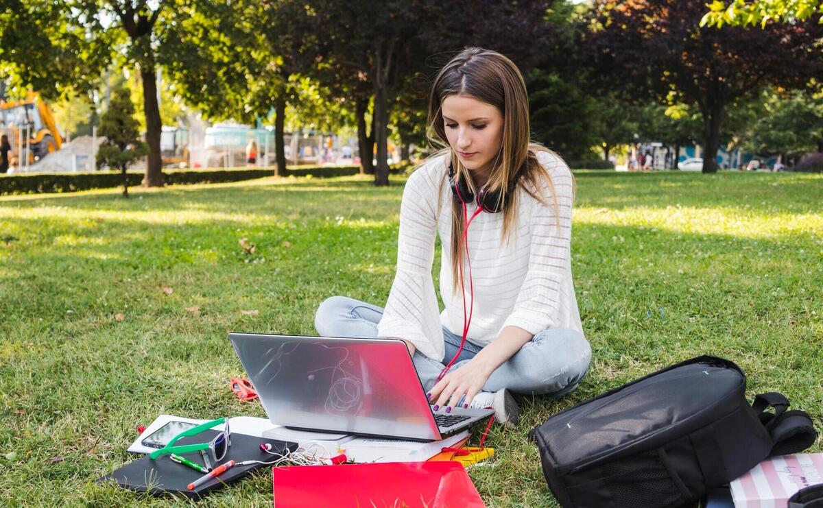 Woman typing on laptop while studying