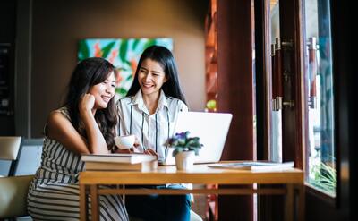 Two beautiful women talking everything together at coffee shop cafe