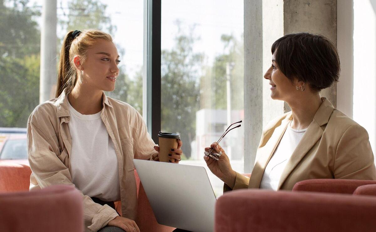 Side view women discussing at work