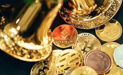 a pile of gold and silver coins sitting on top of a table