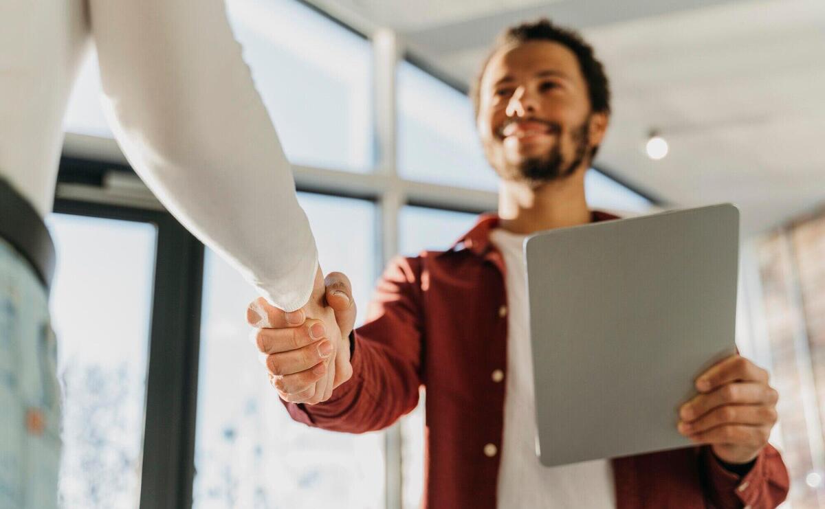 Close up business people hand shake