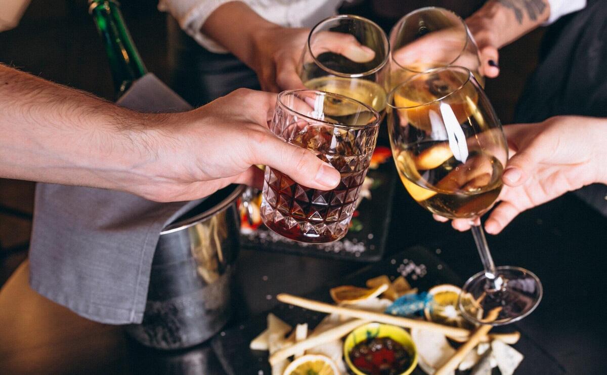 Male and female hands close up with cocktails