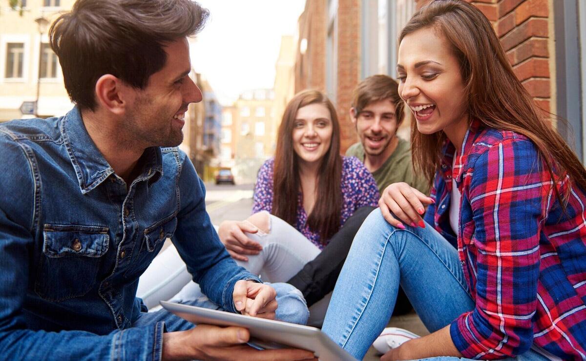 Young people sitting on the pavement