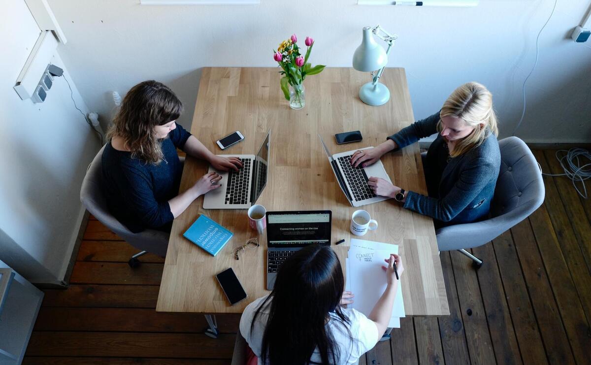 Women are sitting around a table.