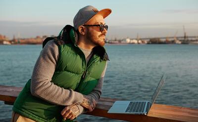 In search of inspiration. Outdoor picture of handsome fashionable guy with neat beard