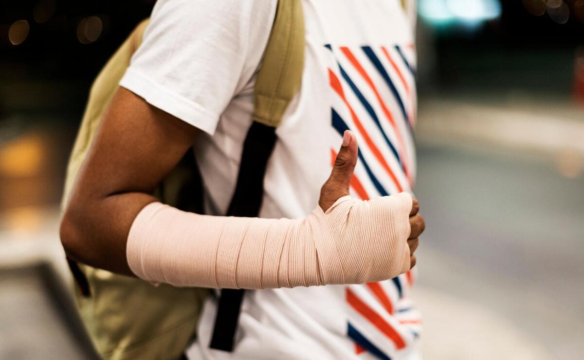 Injured young man with arm support