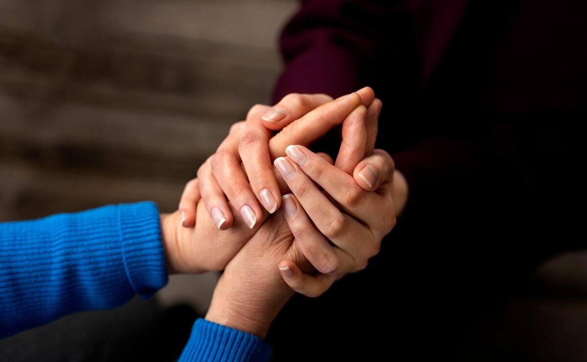 Hands holding each other for support