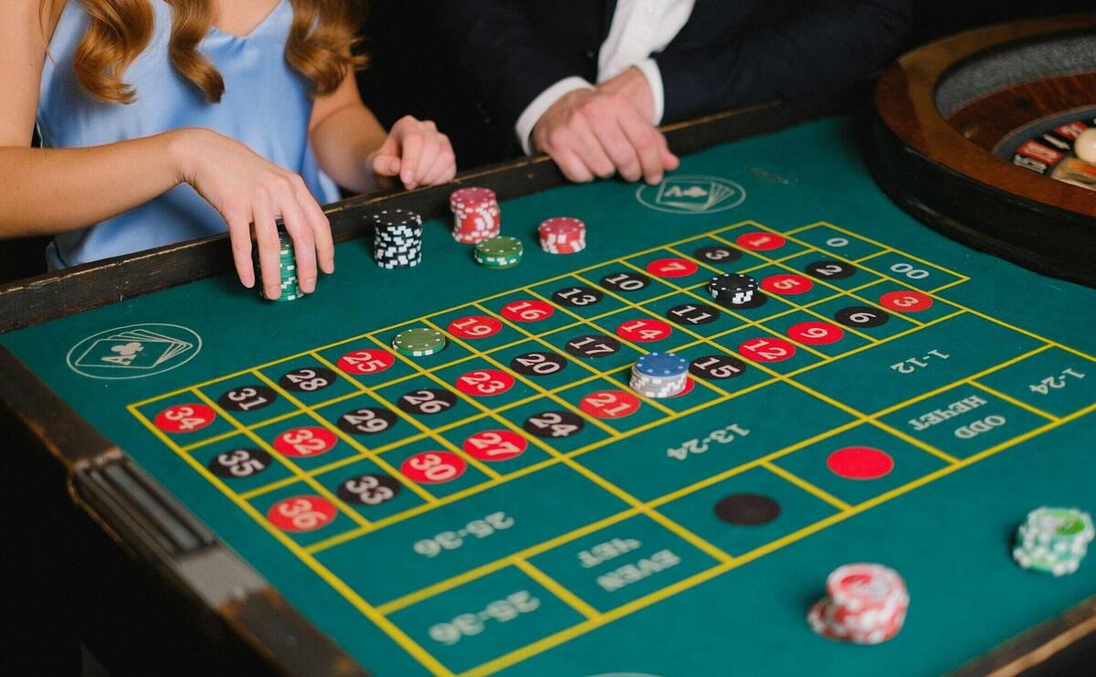 Captivating scene of a casino roulette table with gamblers placing their bets.