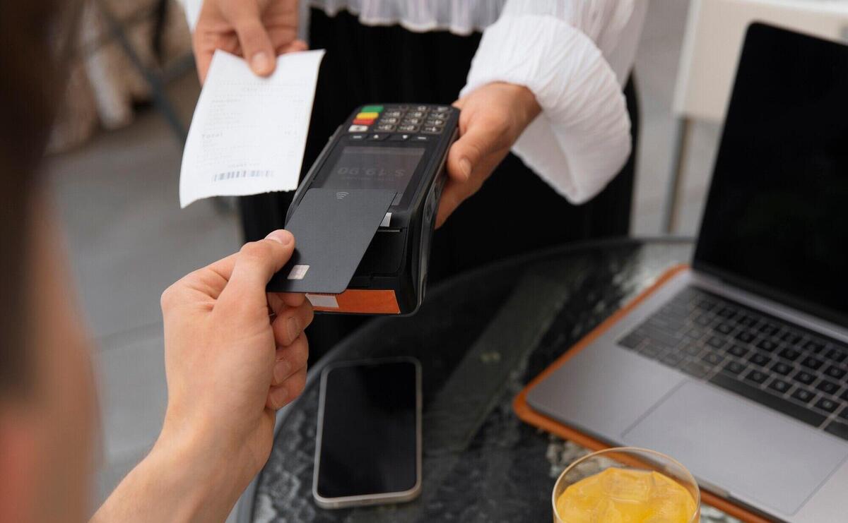 High angle customer paying with nfc device