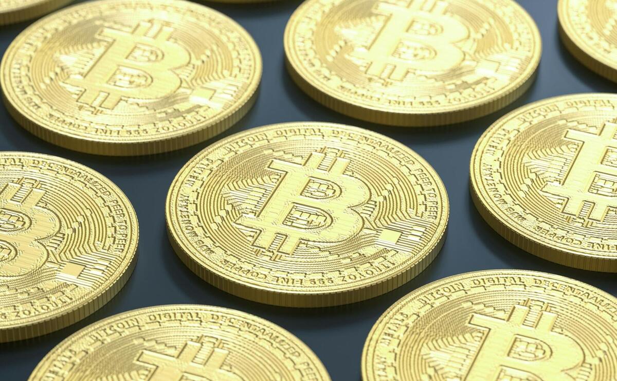 a pile of gold bitcoins sitting on top of a table