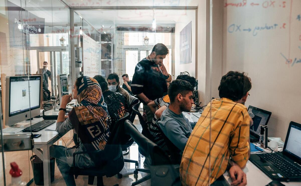 a group of people sitting at computers