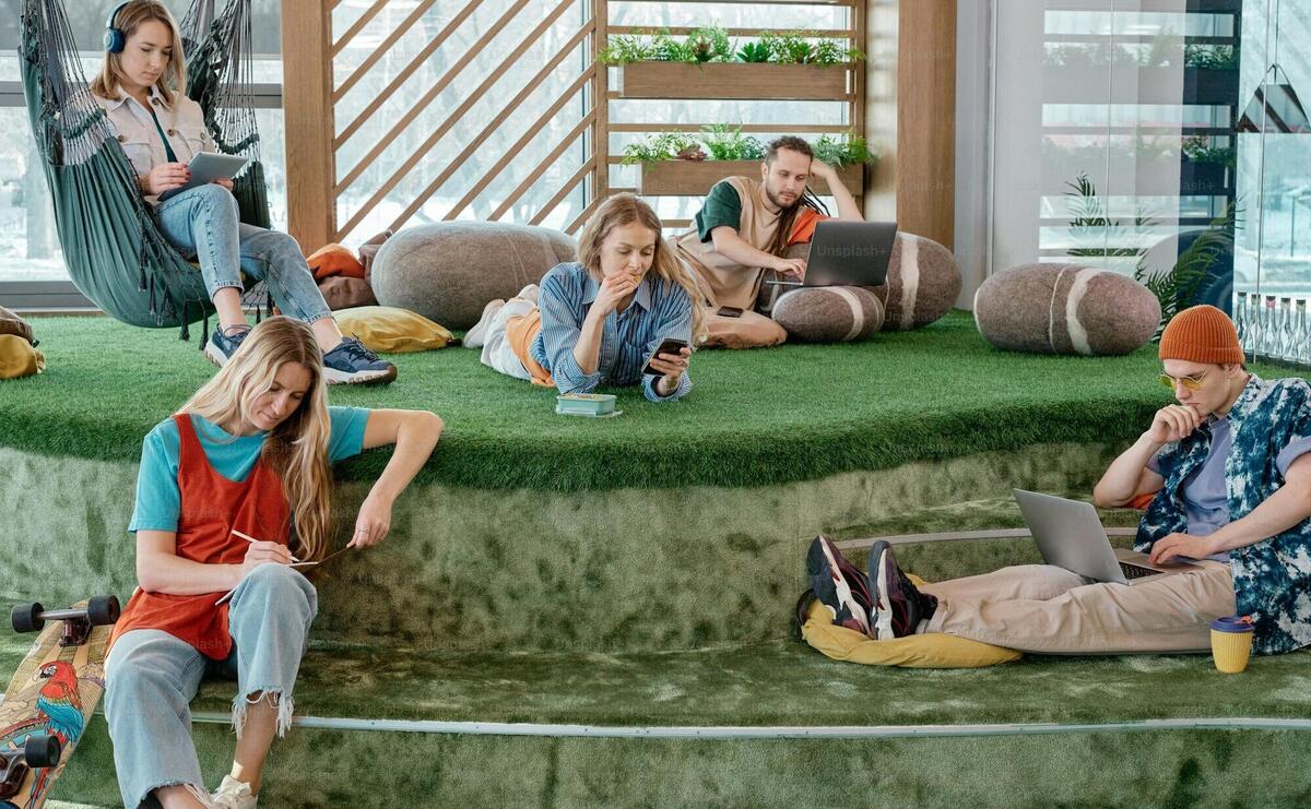 a group of people sitting on top of a green platform