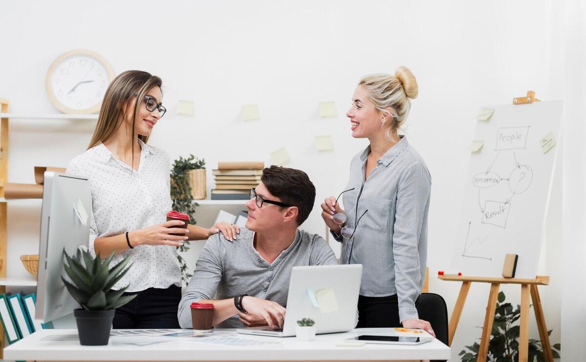 Woman offering coffee to a man at office