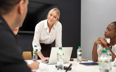 Women discussing business at desk