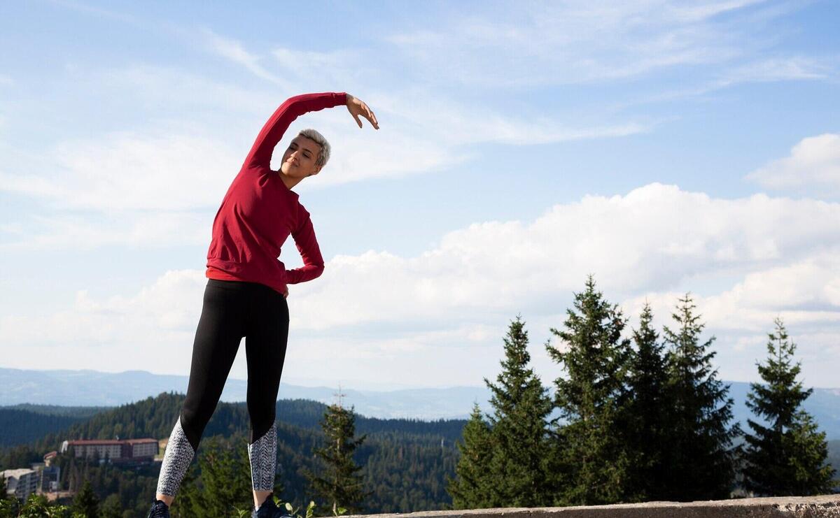 Sporty woman stretching in nature
