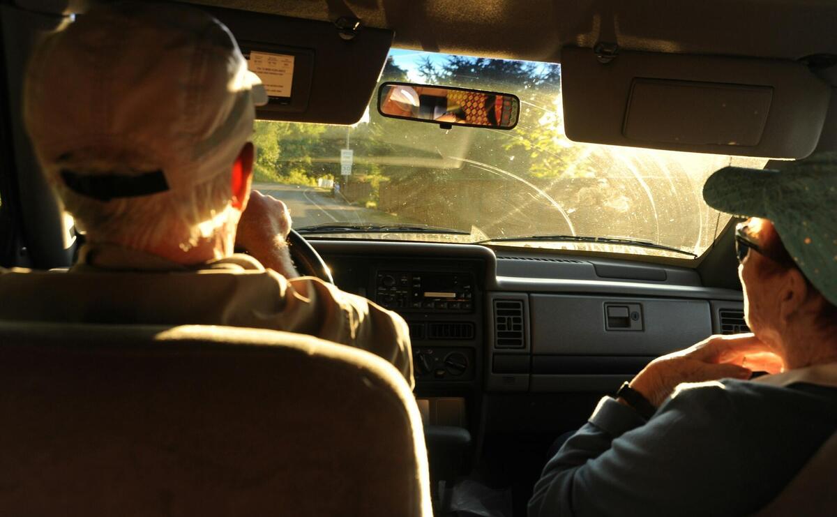 man and woman sitting on car front seat