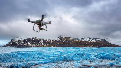 Drone with a camera is flying on iceberg.