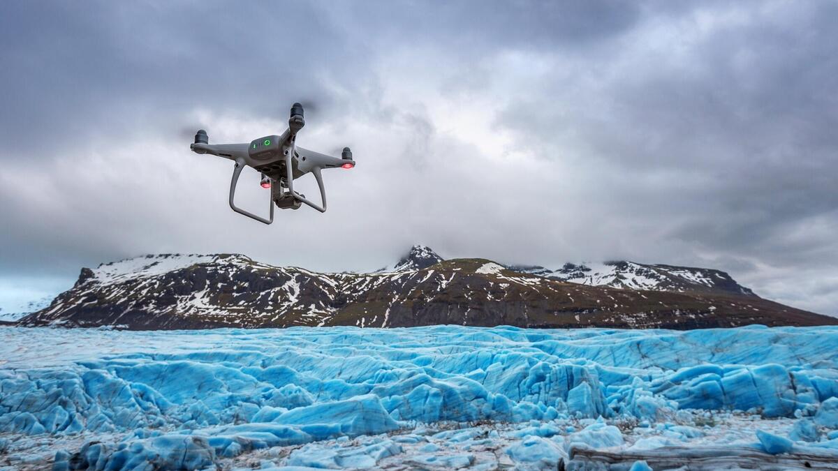 Drone with a camera is flying on iceberg.