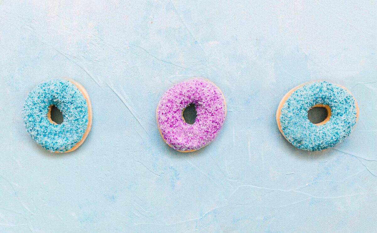 High angle view of colorful donuts on blue background