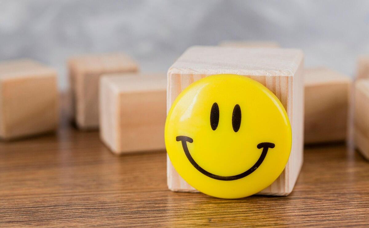 Front view of smiley face on wooden block