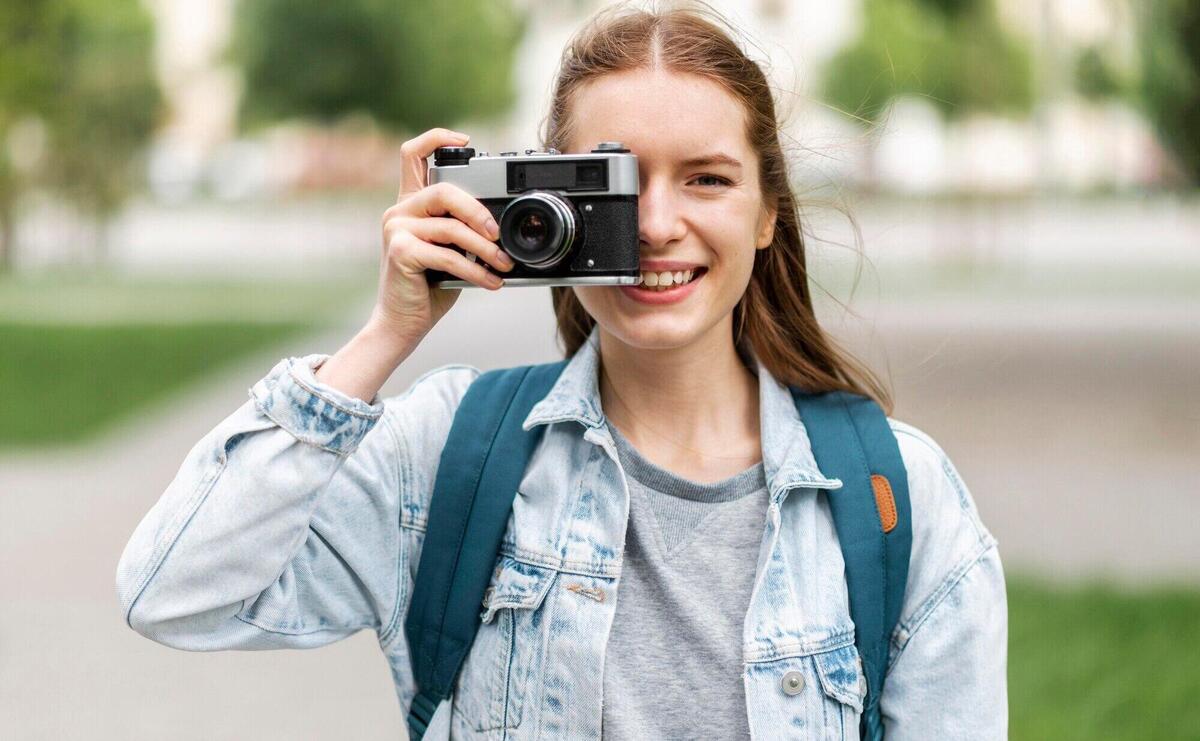 Traveller taking a photo with retro camera