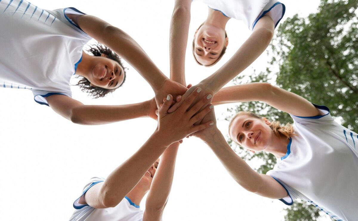 Bottom view women holding hands