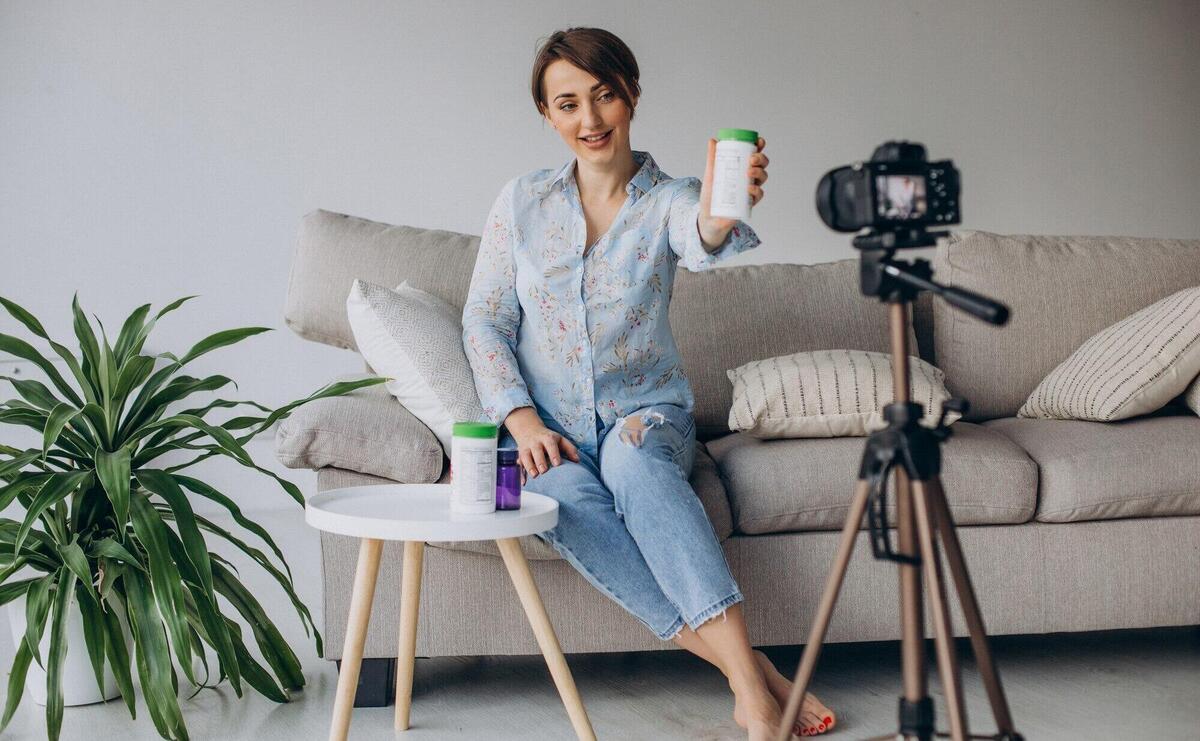 Young woman blogger recording video on camera