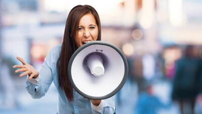 Front view of angry woman with bullhorn