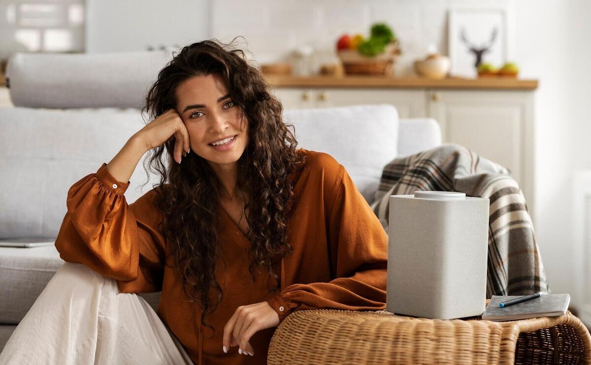 Smiley woman with smart speaker front view