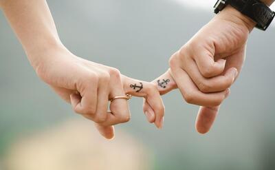 Valentines day background, couple, hands, tattoos, fingers, intertwined, anchor tattoos, lovers, together, touch, relationship, closeup