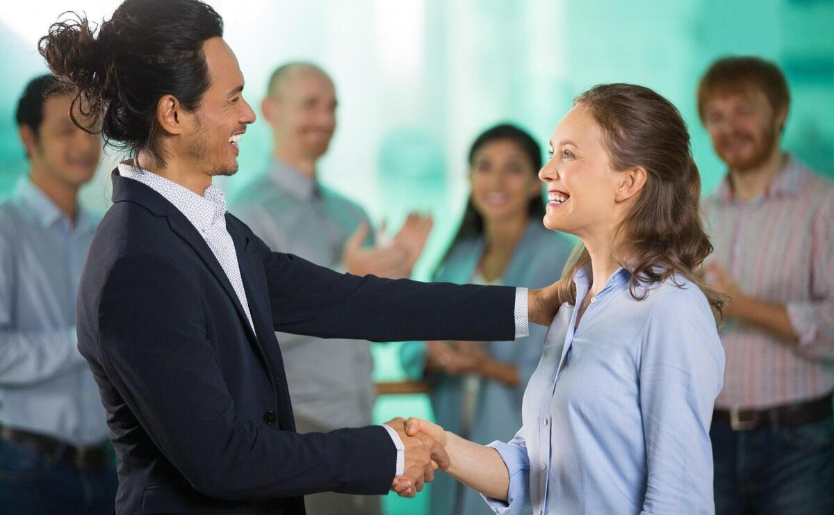 Smiling Business Man Congratulating Colleague