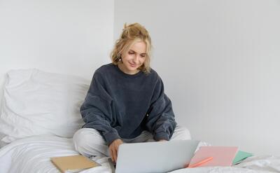 Image of happy young woman student elearning from home connect to online course on her laptop sits