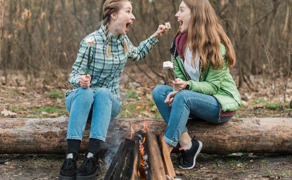 High angle women eating marshmallow