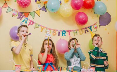 Children with party horns celebrating birthday