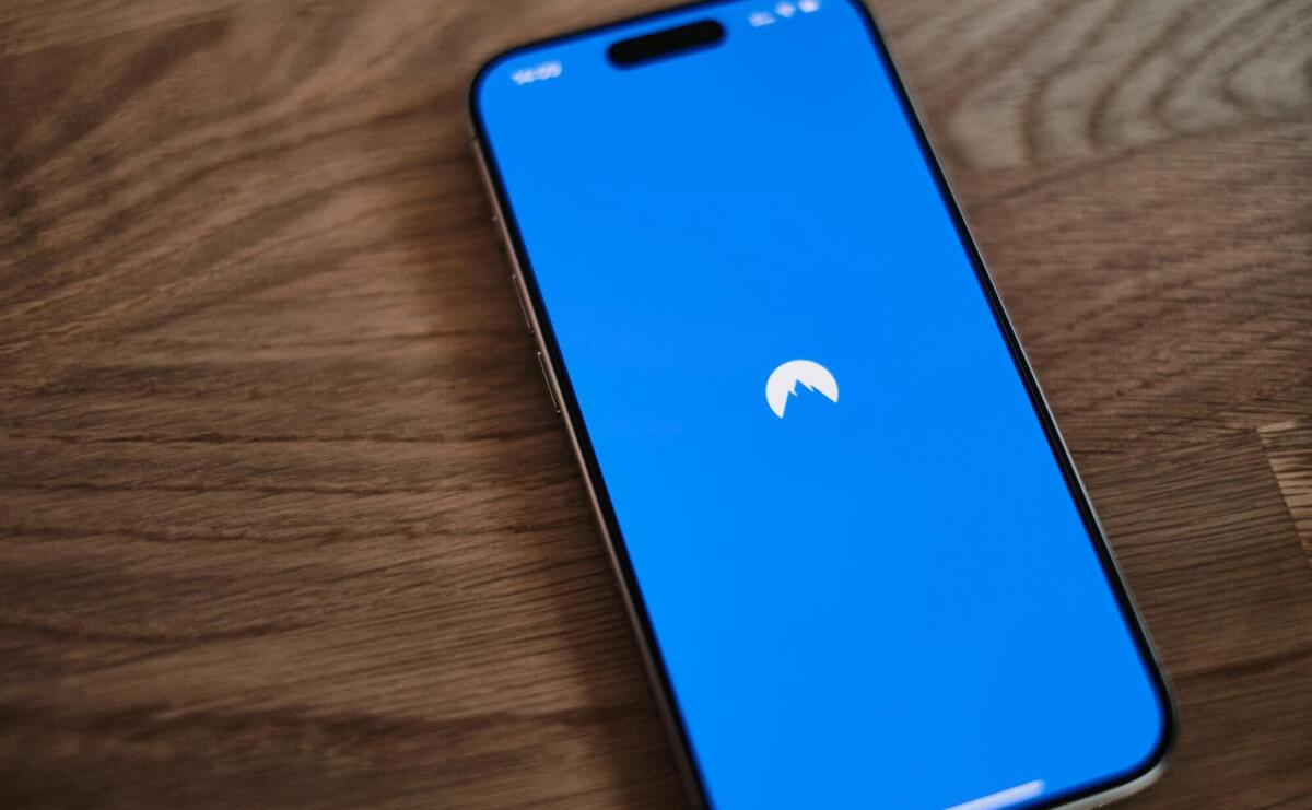 A blue phone sitting on top of a wooden table