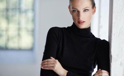 Fashion portrait of brunette woman in black dress.