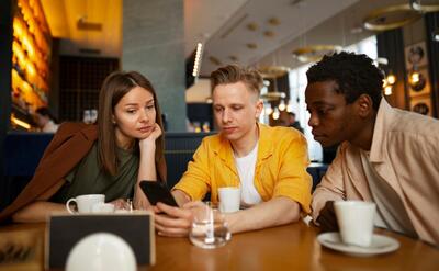 Group of friends looking at the menu together at restaurant