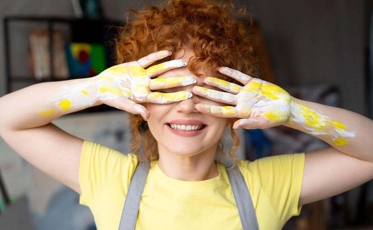 Medium shot woman with yellow paint