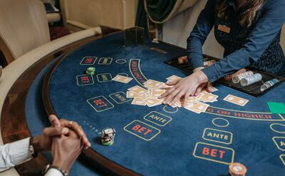 A Woman Dealer Holding Cards