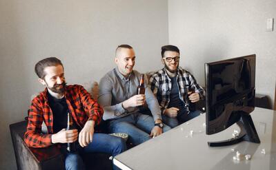 Group of fans are watching soccer on the TV