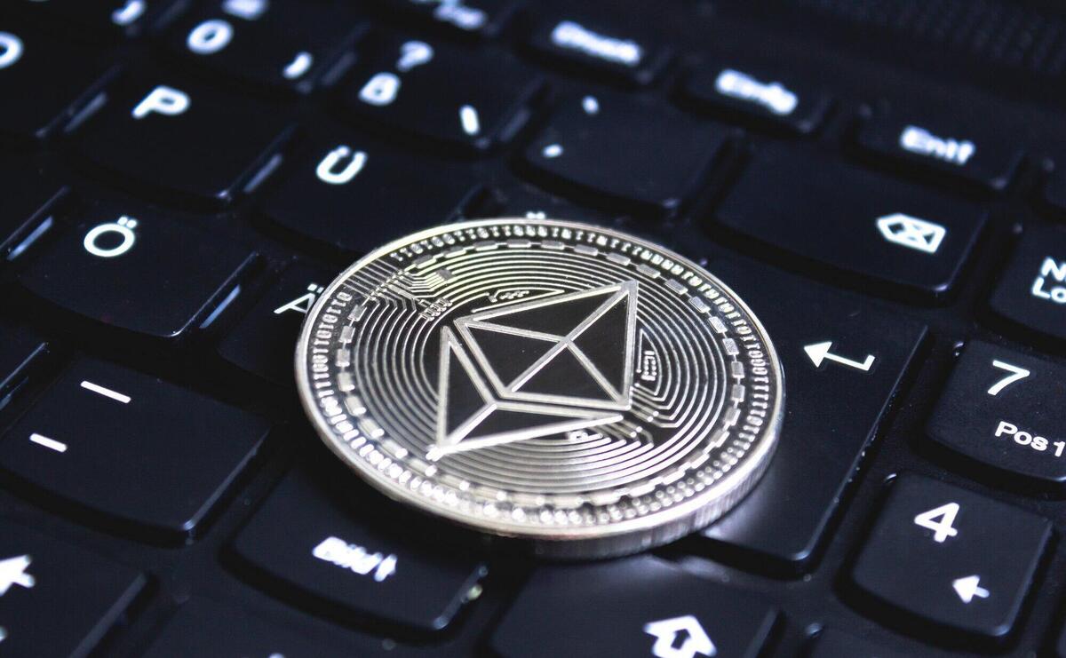 Large coin placed on top of a black computer keyboard