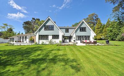 White and Gray Wooden House Near Grass Field and Trees