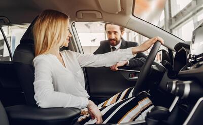 Stylish and elegant woman in a car salon