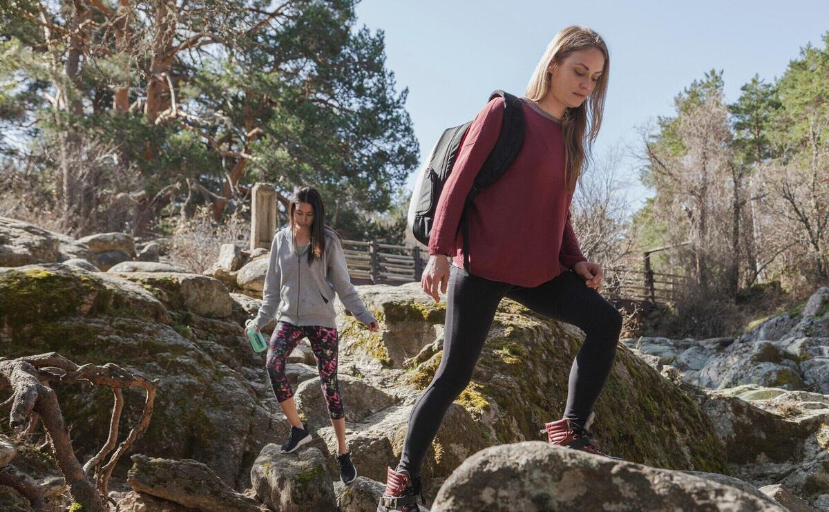 Young woman climbing a rock