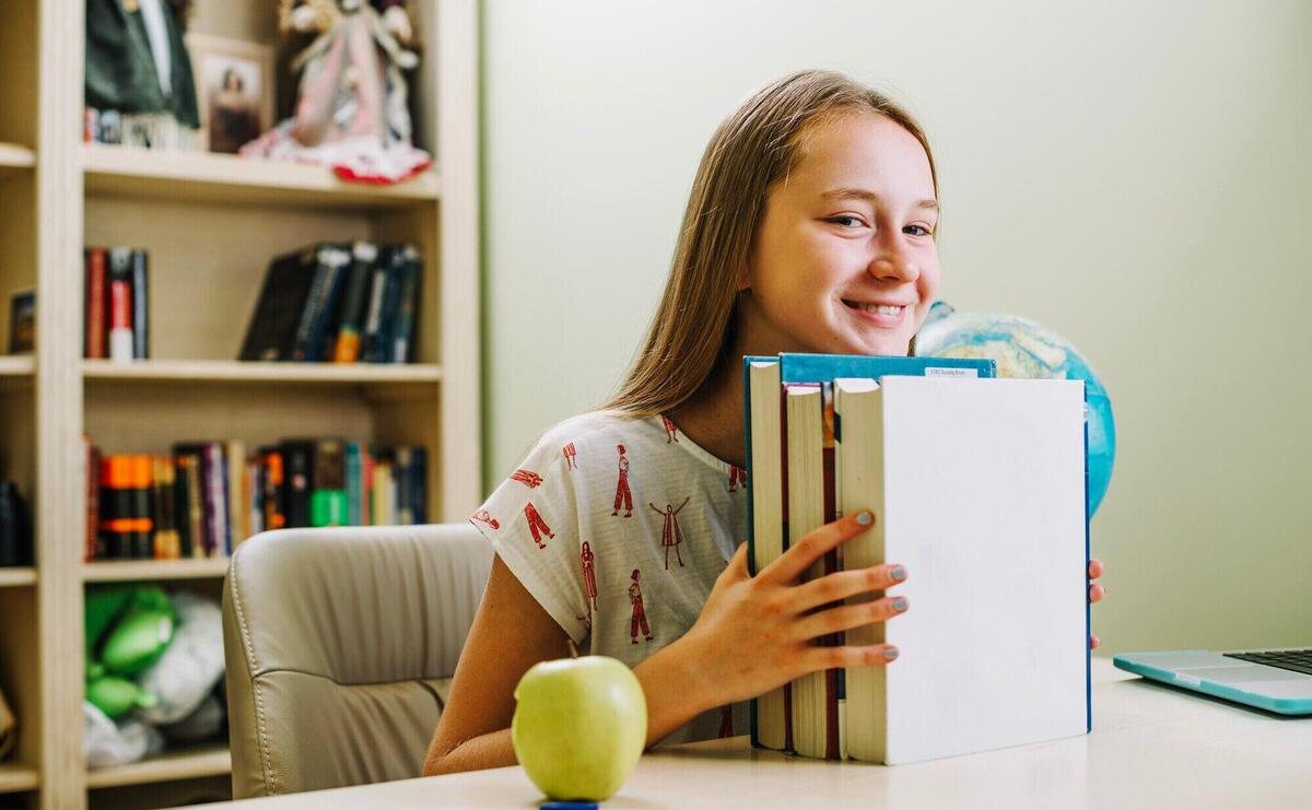 Happy teen girl with books