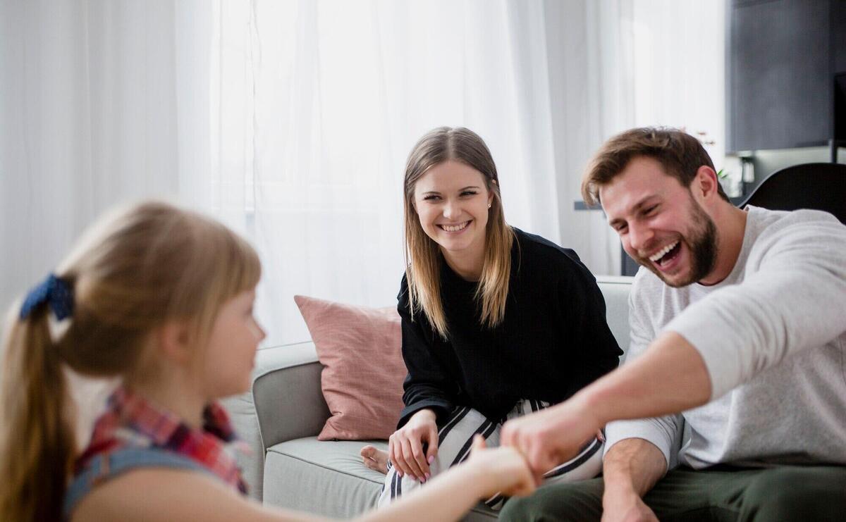 Girl bumping fists with parents