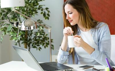 Beautiful young woman working with laptop in her office.