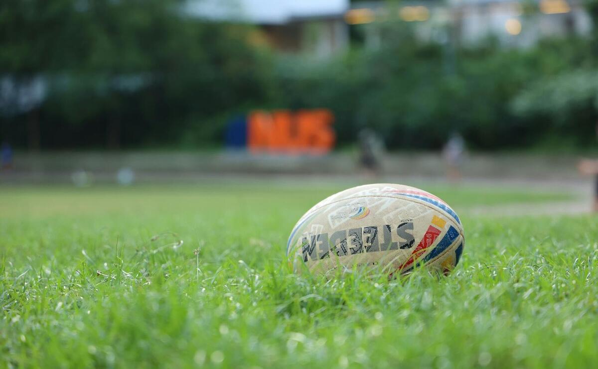 white and red soccer ball on green grass field during daytime