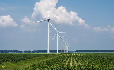 Beautiful view of the wind turbines on a grass covered field captured in Holland